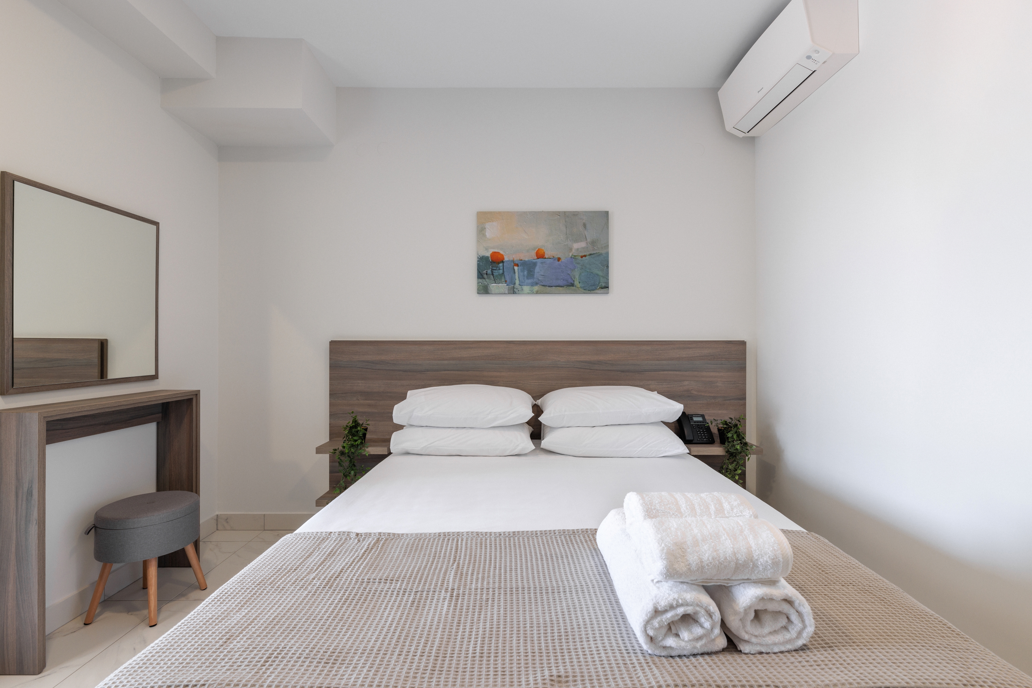 a bedroom with a bed and a desk