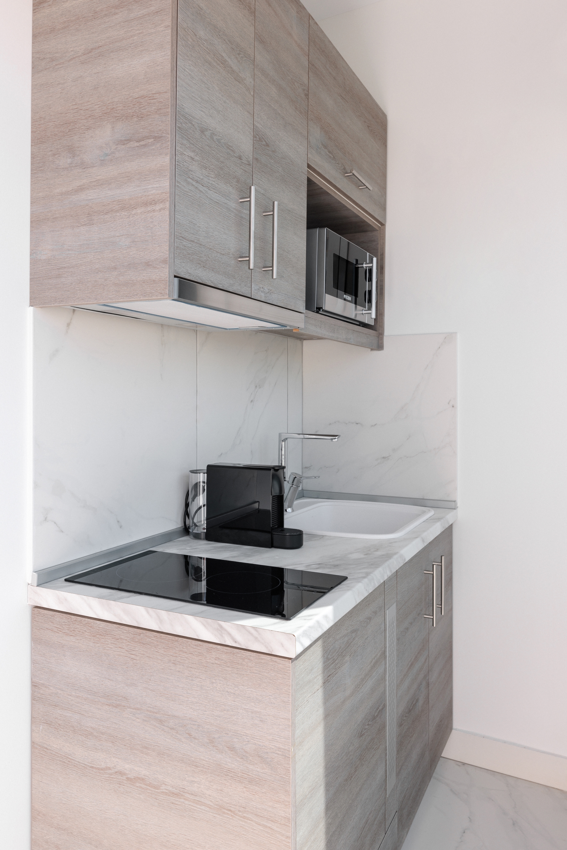 a kitchen with a microwave and cabinets