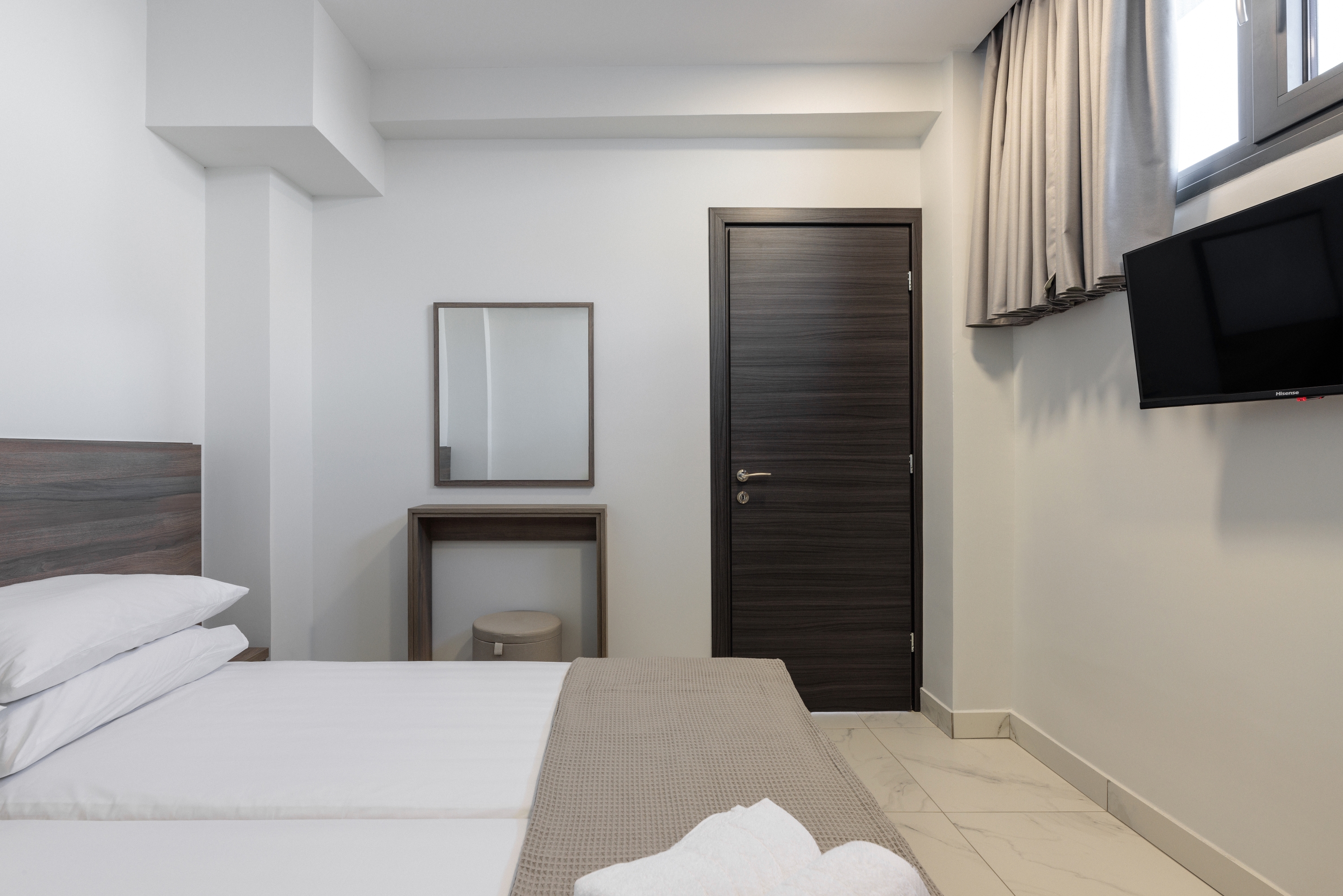 a room with a bed and a tv