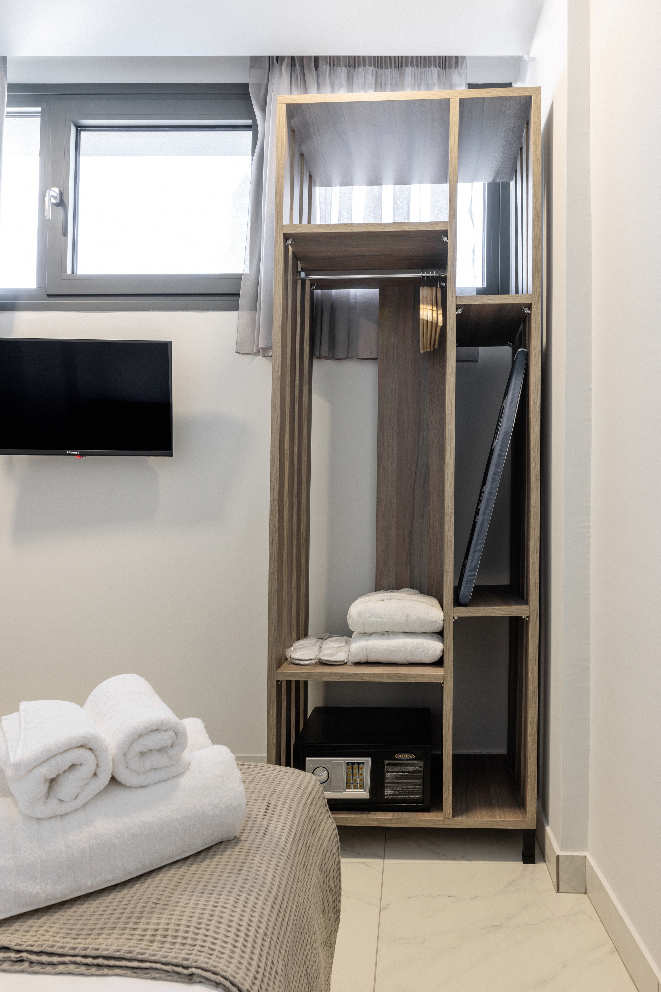 a room with a bed and a television
