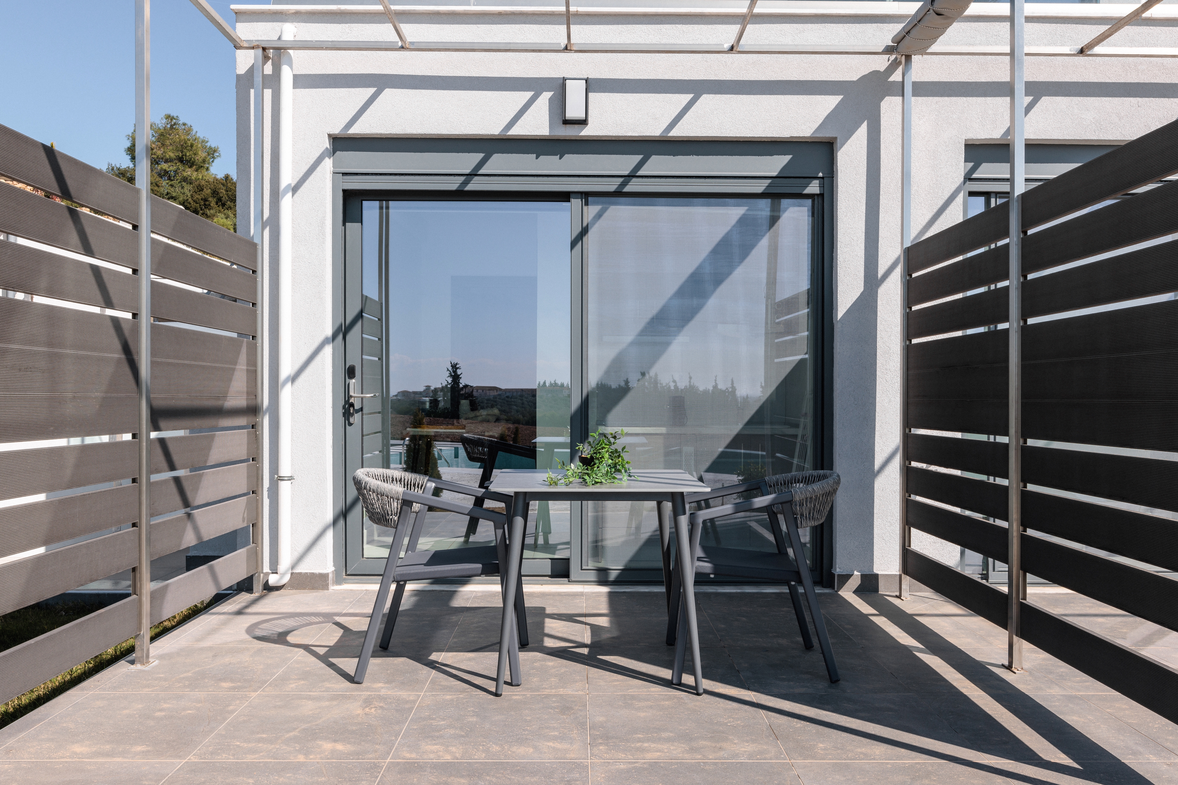 a patio with a table and chairs