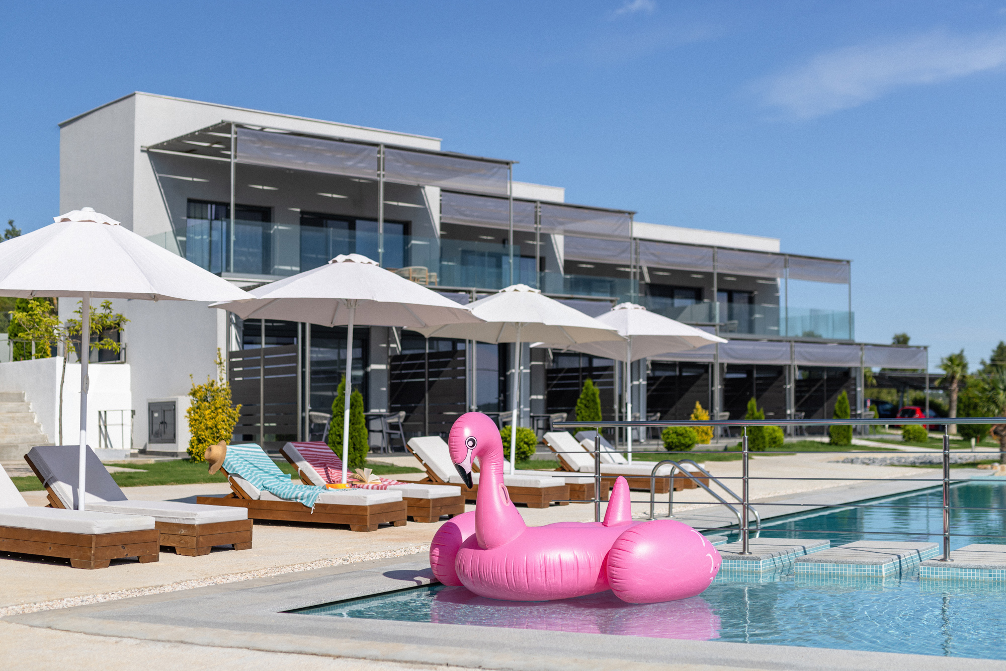 a large building with a pool and a pink piggy bank