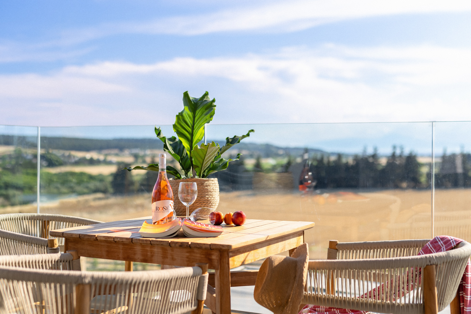 a table with a bottle of orange juice and a glass of orange juice