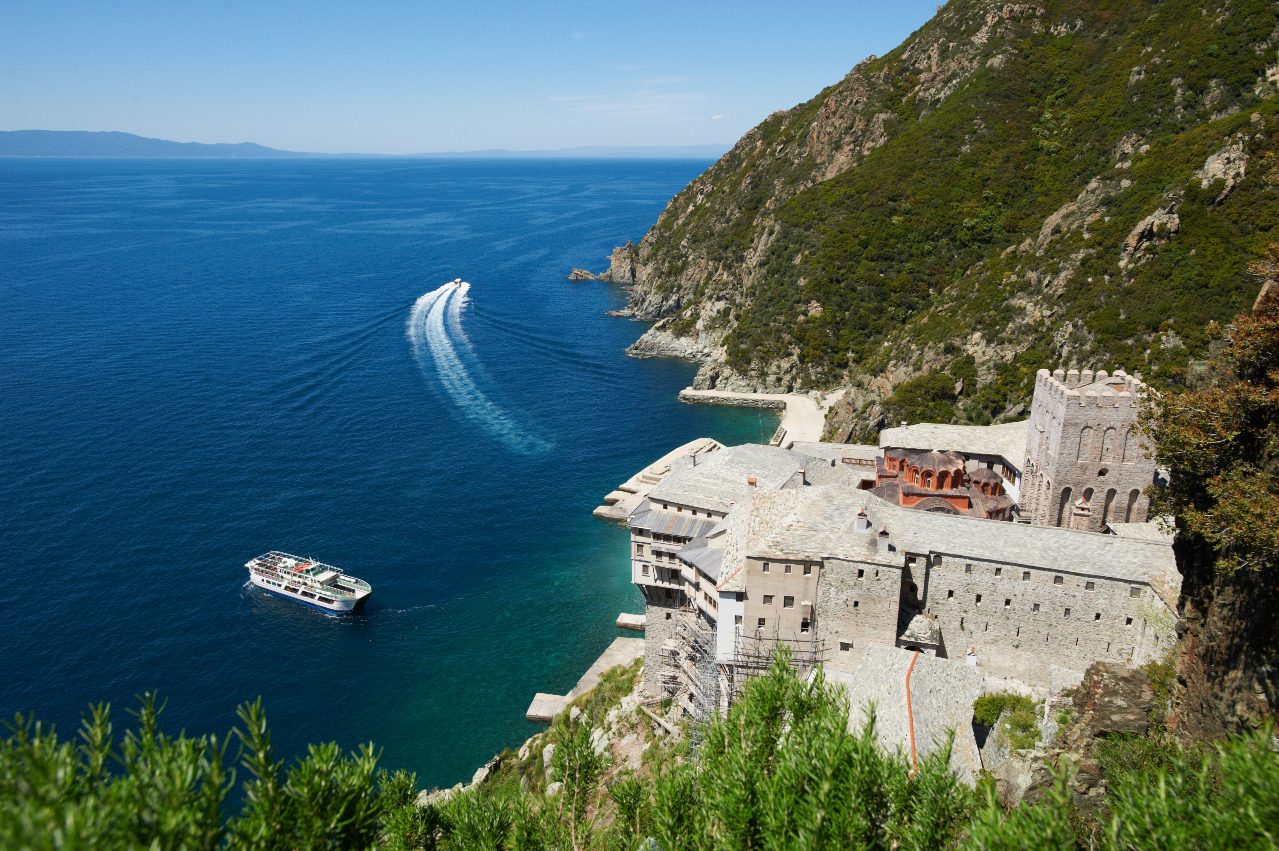a castle on a cliff above the ocean